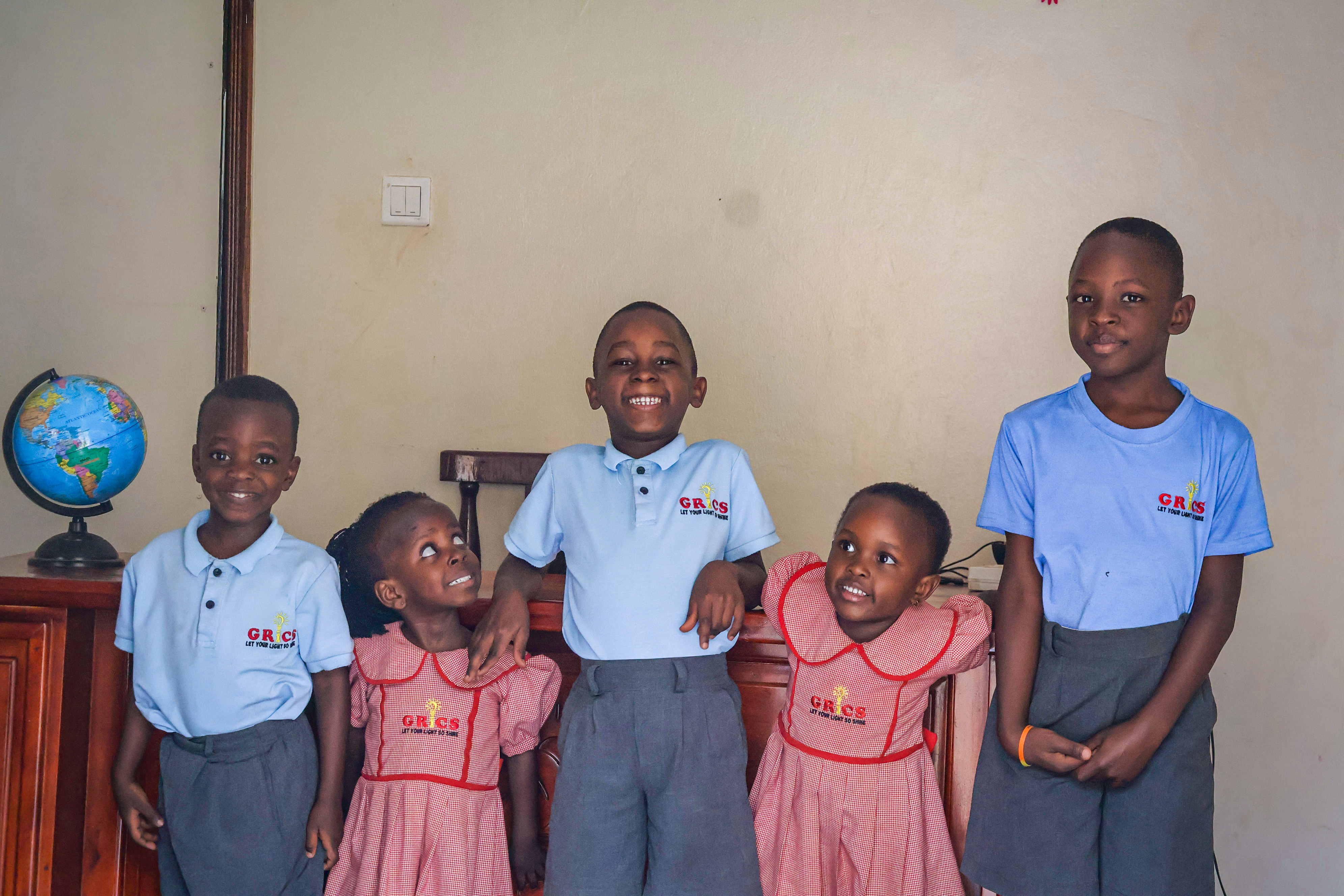 Five GRICS learners posing together in the classroom